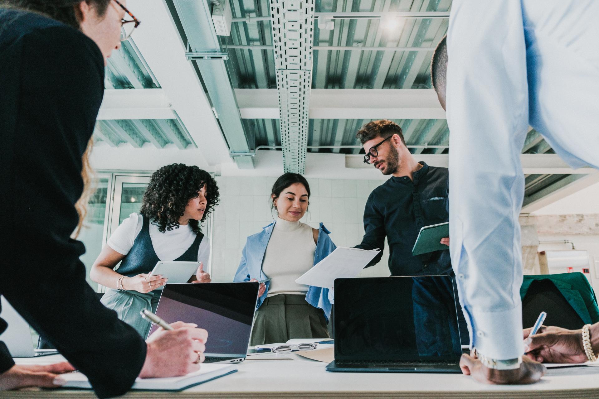 A team of professionals engaged in a collaborative discussion on how to streamline technologies for efficient IT processes.